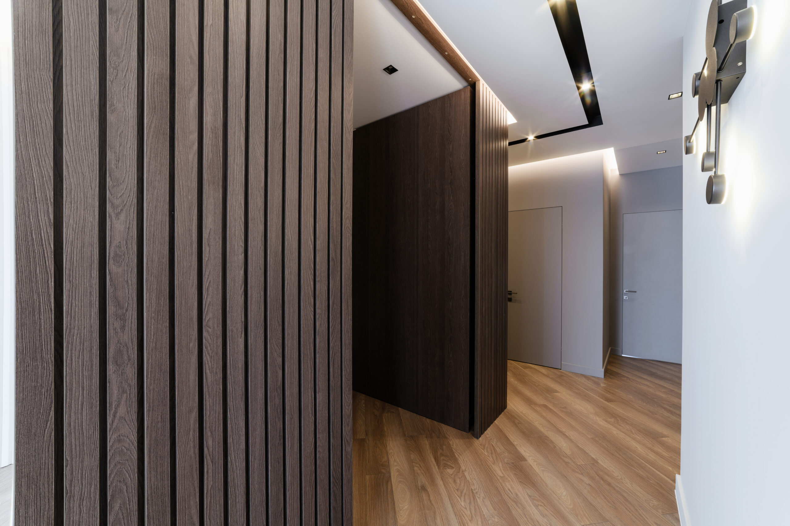 stylish interior of the room with a wooden wall and lighting